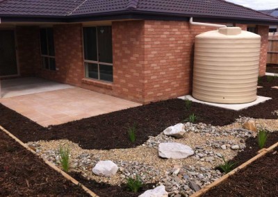 Low maintenance garden with dry river bed